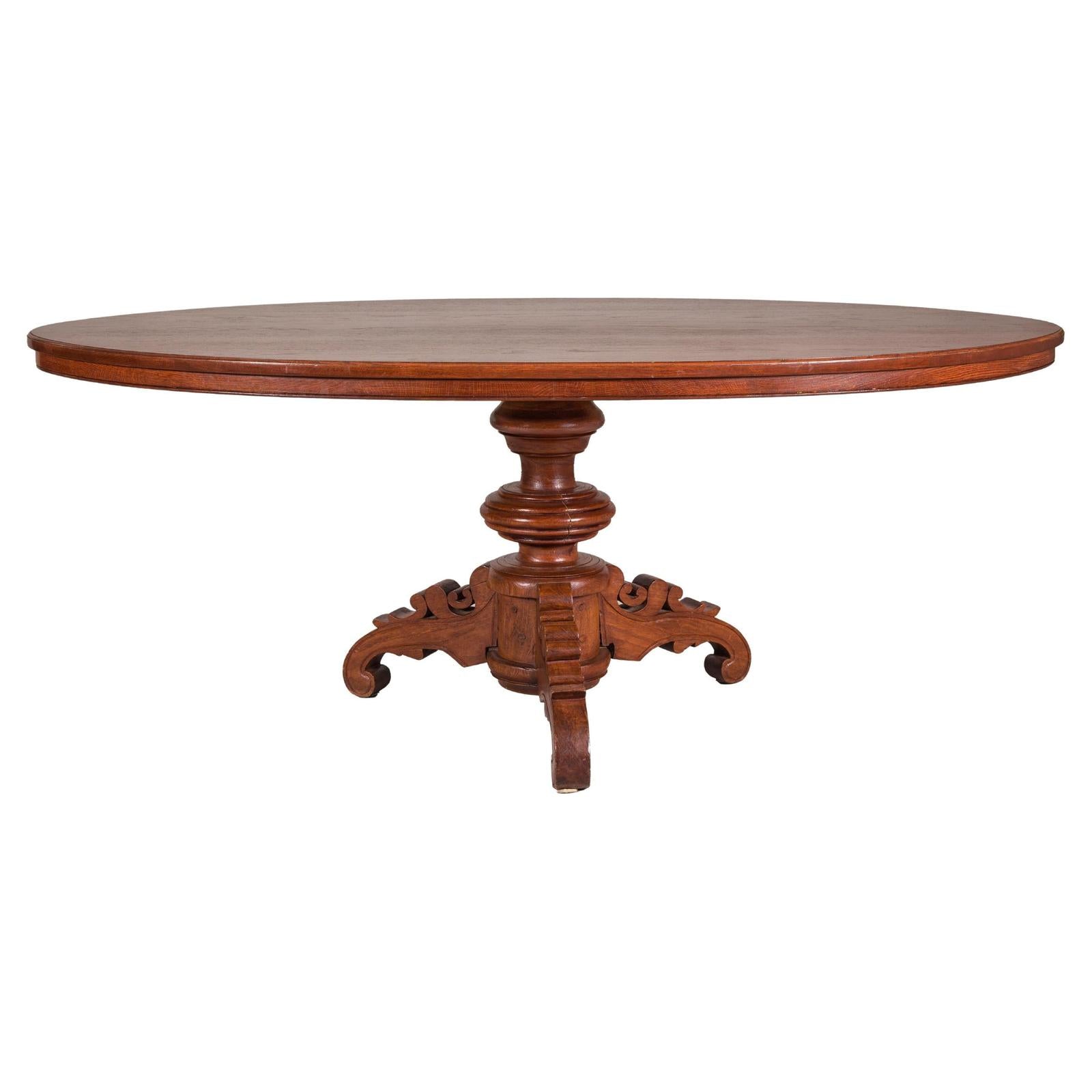 Dutch Colonial Oval Pedestal Dining Table with Scrolling Base, Late 19th Century