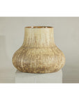 Textured cream and earth-toned ceramic vase on a white pedestal with a neutral background.