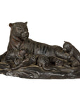 Bronze tiger with three cubs tabletop statue, crafted using the lost wax process, close-up on table.