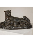 Bronze tiger family statue with mother and three cubs on a white pedestal, tabletop decor, close-up view.