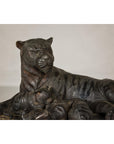 Bronze tabletop statue of a mother tiger and cubs in a realistic style set against a plain background.