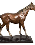 Bronze horse sculpture mid-step with head turned, on black marble base, tabletop display, contemporary style.