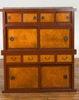 Two-toned wood Japanese Taishō Mizuya Dansu kitchen cabinet with sliding doors and drawers, close-up view.