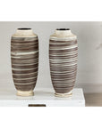 Close-up of two tall ceramic vases with horizontal swirl design on a white surface, neutral background.