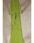 Close-up of curved bench seat with distressed green paint