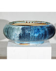 Close-up of a vintage blue Shigaraki style ceramic planter with wide opening on a white pedestal against plain background.