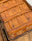 Close-up of the Woven Rectangular Picnic Basket with Handle & Hinged Lid, highlighting its intricate bamboo strips, wooden supports, and natural brown finish—a testament to Southeast Asian craftsmanship on a wooden surface.