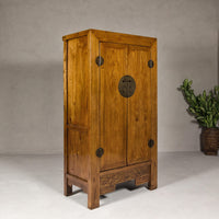 Large Elmwood 19th Cabinet with Carved Apron and Round Brass Medallion