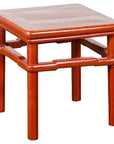 Red wood square side table with straight legs and humpback stretcher, inspired by 19th century Chinese design.