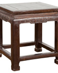 Brown lacquer wood low table with carved apron and horse hoof legs, Qing Dynasty style, isolated on white background.