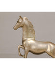 Silver over brass walking horse statuette on ebonized oak base, close-up against plain light background.