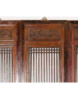 Close-up of black lacquered wood Qing Dynasty screen panels with intricate carved meander motifs, detail view.