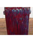 Red and blue ceramic Chinese vintage planter with metal rivets and handles on a wooden floor.