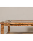 Distressed wood two-tier coffee table with inset top and straight legs, set against a plain light wall.