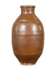 Brown ceramic Meiji period Japanese water jar with narrow neck and minor base chip on a white background.