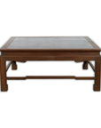 Vintage brown wood low coffee table with Negora lacquered top on white background.