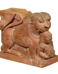 Brown teak guardian lion carving with traces of paint, attacking human on rectangular base, 18th century India.