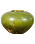 Close-up of olive green porcelain circular urn with glossy finish and small top opening.