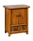 Dark wood Chinese Qing Dynasty bedside cabinet with tapering lines and round metal handles, 19th century.