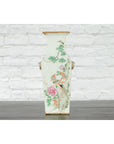 White porcelain altar vase with hand-painted flowers and birds, Chinese Qing 19th c., displayed against a brick wall.