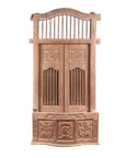 Natural wood balcony window with hand-carved foliage motifs and bonnet top, antique Indian frame, close-up view.