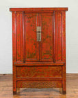 Antique red lacquer wood cabinet with gold floral designs and double doors, on wooden floor.