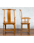 Natural wood Chinese Qing Dynasty 19th century lamp hanger chairs, front and side views, white brick wall background.