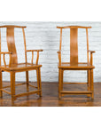 Natural wood Chinese Qing Dynasty 19th century lamp hanger chairs with patina on wooden floor against white brick wall.