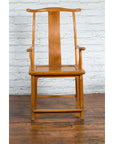 Natural wood Qing Dynasty lamp hanger chairs with aged patina, set against a white brick wall on a wood floor.