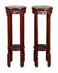 Brown wood round Chinese stands with carved legs, painted floral and bird designs, close-up on pair.