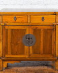 Brown elmwood side chest with two drawers, two doors, and bronze medallion hardware, early 20th century Chinese style.