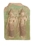 Green-painted stone plaque with Thai ceremonial dancers and intricate headpieces, temple wall decor, close-up.