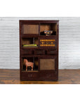 Brown wood tansu cabinet with sliding doors and drawers, Japanese early 20th century, front view.