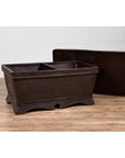 Dark brown rattan Chinese antique basket coffee table with lid on wooden floor.