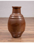 Brown glazed ceramic Japanese Tamba Tachikui ware water jug with narrow neck on wooden surface, 19th century.