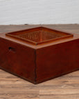 Rectangular Keyaki wood hibachi with copper liner, Japanese 19th c., on wooden floor by white brick wall.