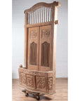 Natural wood balcony with hand-carved foliage motifs and bonnet top, inspired by antique Indian window design.