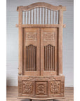 Natural wood balcony with hand carved foliage motifs and bonnet top, inspired by antique Indian windows.