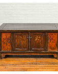 Brown wood Chinese Qing 19th-century coffee table with painted floral decor and storage, on hardwood floor by white brick wall.
