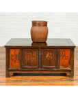 Natural woven basket on carved wood cabinet beside Chinese Qing 19th century wood coffee table with floral decor and storage.