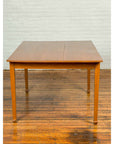 Brown wooden vintage Chinese dining table with spade feet on a polished wooden floor, classical simple design.