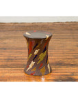 Blue and white glazed ceramic garden seat with abstract hand-painted patterns on a wooden floor.
