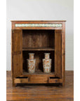 Brown wood Indonesian 19th-century cabinet with open doors, sunburst and blue tile accents, vases, two open drawers.