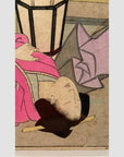 Close-up of an antique wood-framed Japanese Shunga woodblock print featuring a couple making love.