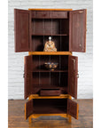 Dark wood Chinese Qing Dynasty cabinet with Chinoiserie panels, open to show shelves, a bowl, statue, and drawer.