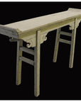 Wood altar table with curved supports and splayed legs, vintage style, against a solid black background.