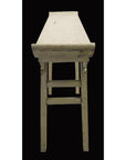 Front-facing altar table made of aged white wood with worn paint, photographed against a black background.