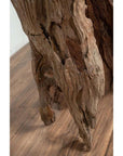 Brown driftwood carving close-up, ancient wood sculpture from Chiang Mai, Northern Thailand, on wooden surface.