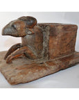 Weathered wood animal noodle maker with ram's head and legs, antique style, close-up on flat base.