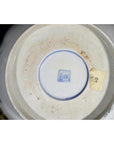 White porcelain bowl with hand painted Asian design, close-up view.
